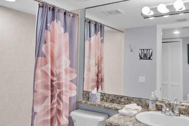 bathroom featuring vanity, toilet, and a shower with shower curtain