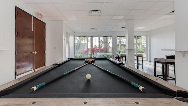 rec room featuring plenty of natural light, pool table, and a drop ceiling