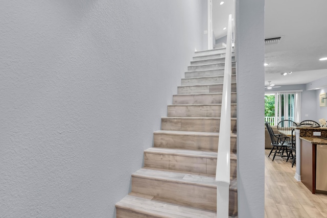 staircase featuring hardwood / wood-style flooring