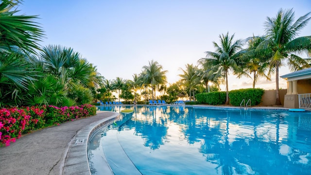 view of pool at dusk