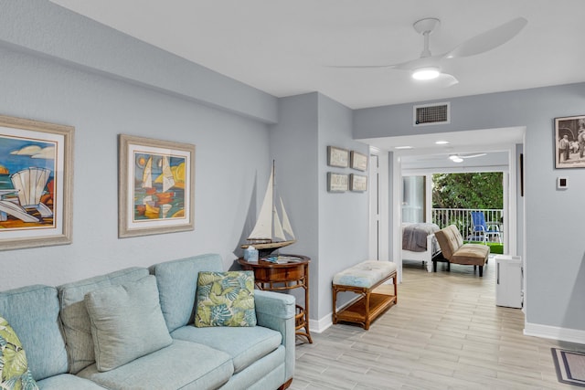 living room with light hardwood / wood-style flooring and ceiling fan