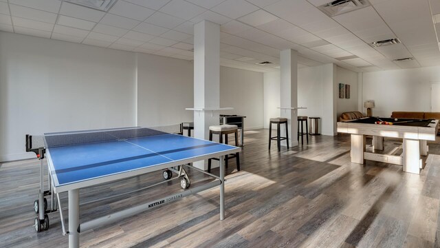 rec room with wood-type flooring and a drop ceiling