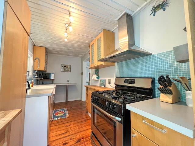 846 Olivia St, Key West, FL 33040 - kitchen featuring stainless steel gas stove, island range hood, light wood finished floors, light countertops, and backsplash