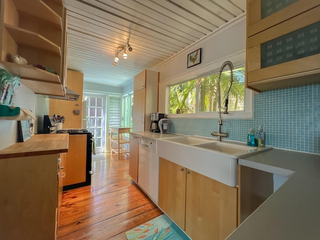 846 Olivia St, Key West, FL 33040 - kitchen with stainless steel range with gas cooktop, white dishwasher, light wood finished floors, a sink, and backsplash