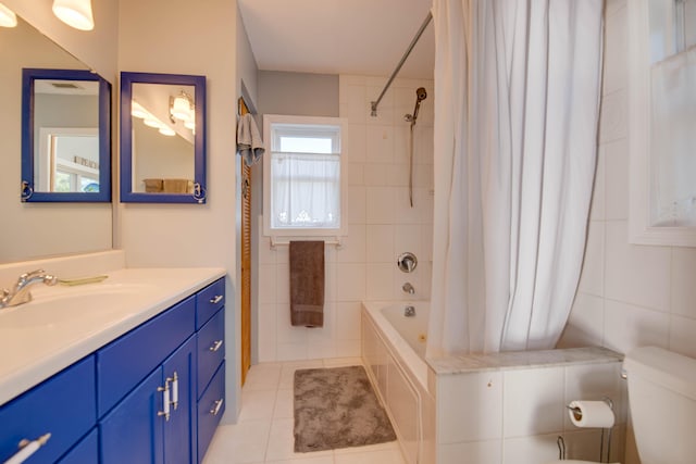 full bathroom featuring shower / tub combo, tile patterned flooring, tile walls, vanity, and toilet