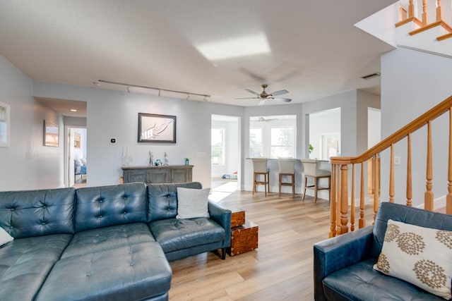 living room featuring ceiling fan, track lighting, and light wood-type flooring