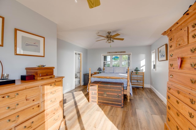 bedroom featuring ceiling fan, connected bathroom, and light hardwood / wood-style flooring