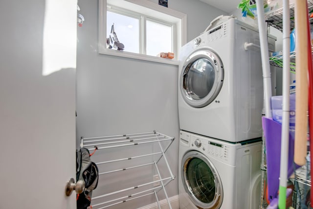 laundry area featuring stacked washer / drying machine