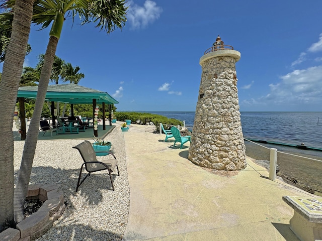 view of community with a gazebo and a water view