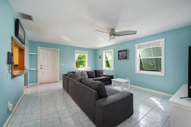 living room with ceiling fan and light tile patterned flooring