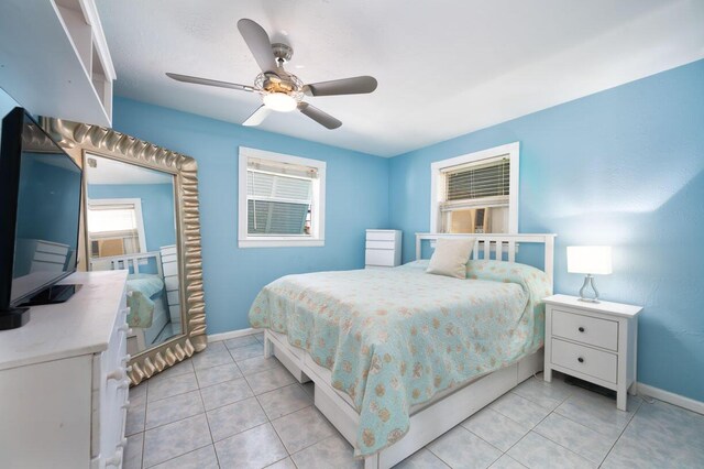 tiled bedroom featuring ceiling fan