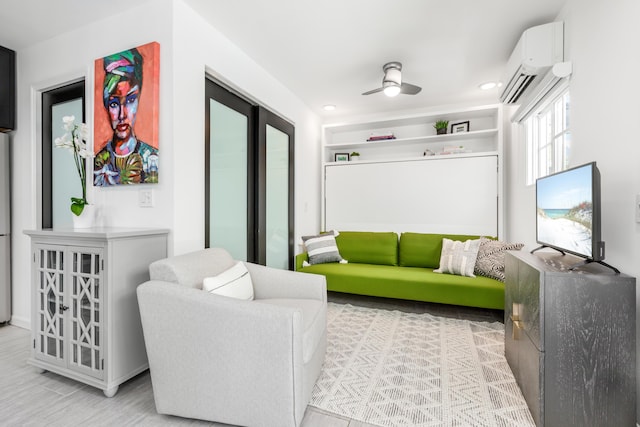 living area with a wall mounted AC, a ceiling fan, and recessed lighting