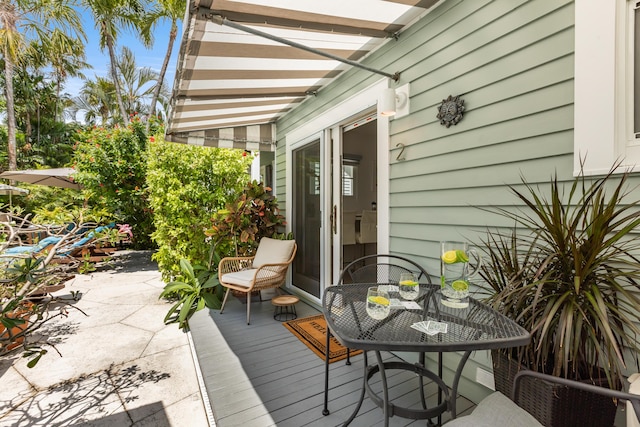 wooden terrace featuring outdoor dining space