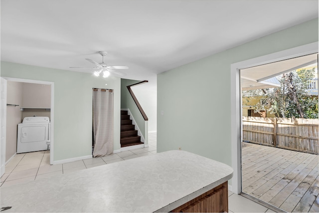 3212 Harriet Ave, Key West, FL 33040 - kitchen with light tile patterned floors, baseboards, washing machine and dryer, and a ceiling fan