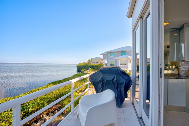 view of swimming pool featuring a water view and a patio area