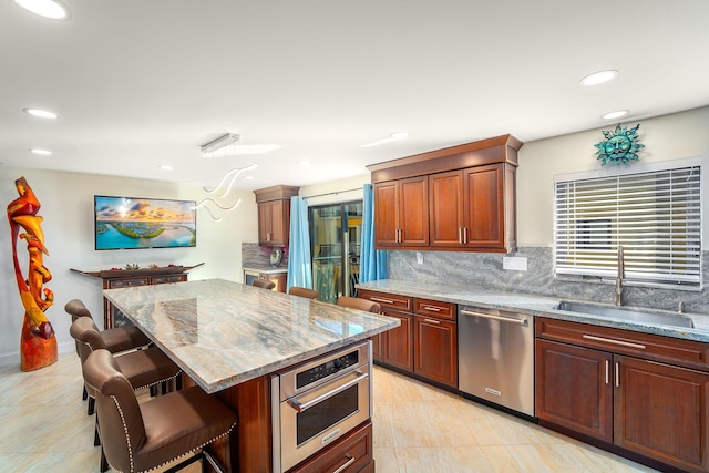 1616 Atlantic Blvd Unit 6, Key West, FL 33040 - kitchen featuring a breakfast bar area, decorative backsplash, a sink, and stainless steel appliances