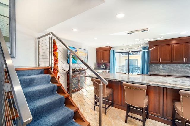 1616 Atlantic Blvd Unit 6, Key West, FL 33040 - kitchen with decorative backsplash, light stone countertops, and a kitchen bar