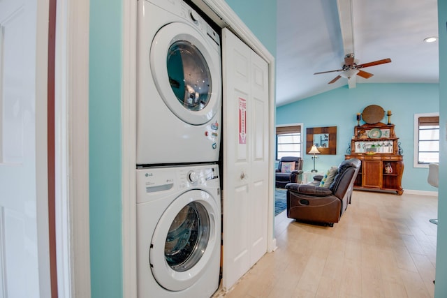 laundry area with light hardwood / wood-style floors, stacked washer and clothes dryer, and ceiling fan