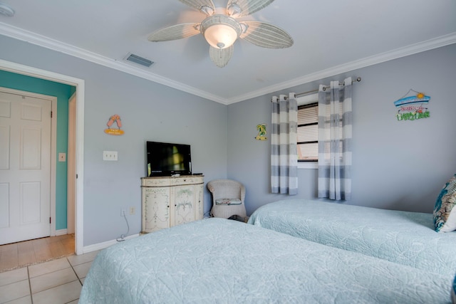 tiled bedroom featuring ornamental molding and ceiling fan