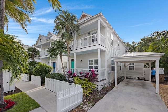 view of front of property featuring a balcony, a porch, and a carport