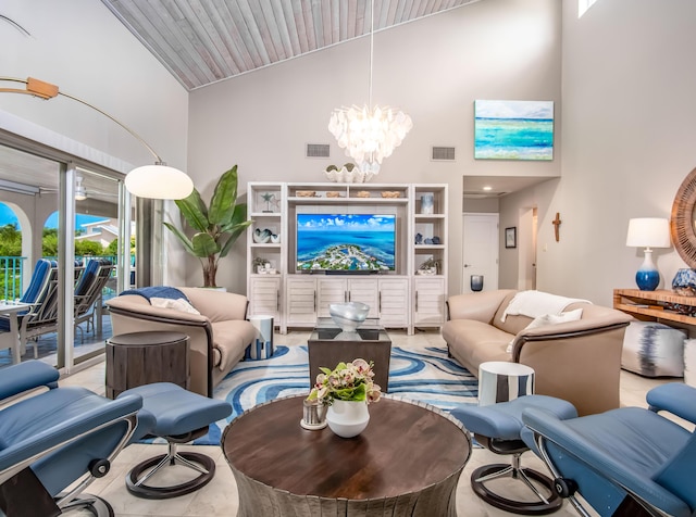 living room featuring a notable chandelier and high vaulted ceiling