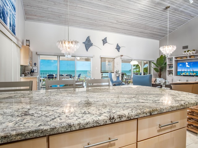 kitchen with light stone countertops, pendant lighting, wooden ceiling, and a chandelier