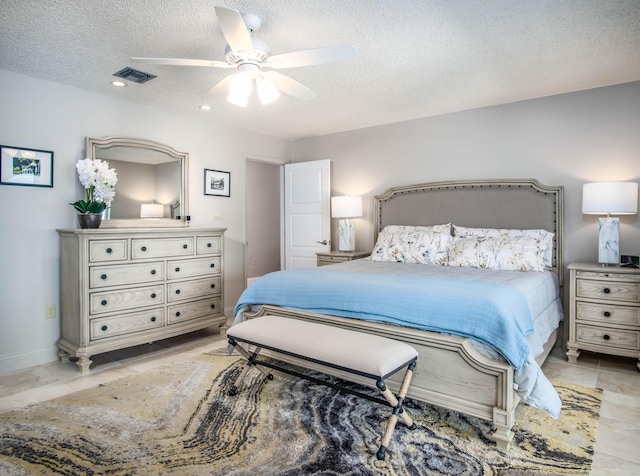 bedroom with ceiling fan and a textured ceiling