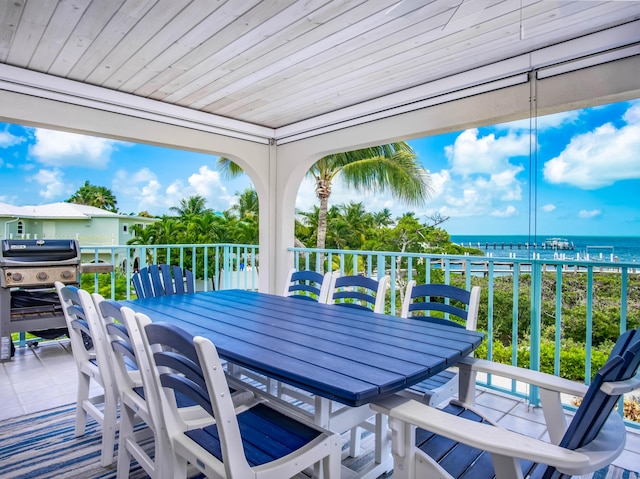 wooden deck featuring a water view and area for grilling