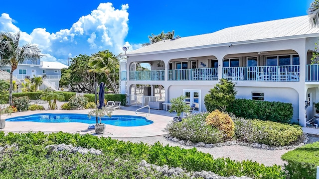 view of pool with a patio and french doors