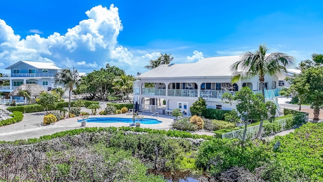 back of house with a fenced in pool, a patio area, and french doors