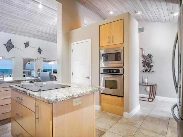 kitchen with appliances with stainless steel finishes, a center island, light stone counters, wooden ceiling, and light brown cabinets