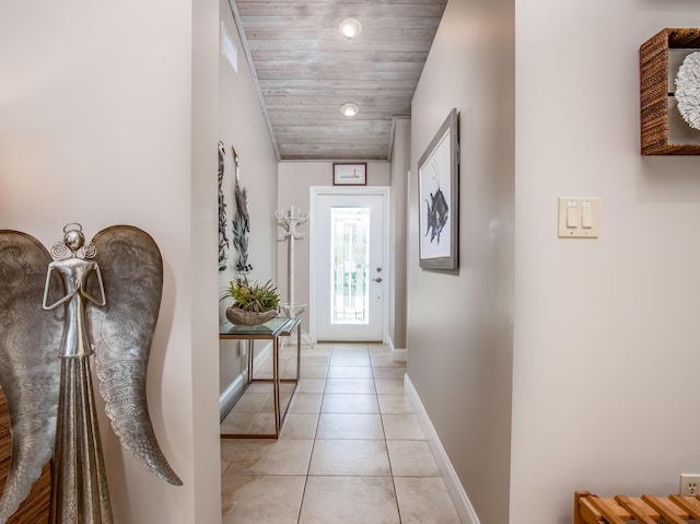 doorway featuring light tile patterned floors and wooden ceiling