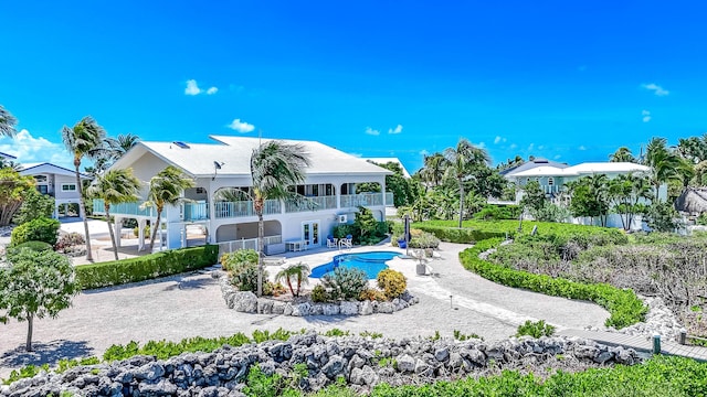 back of property featuring french doors and a balcony