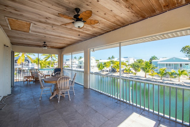 unfurnished sunroom with wooden ceiling and ceiling fan