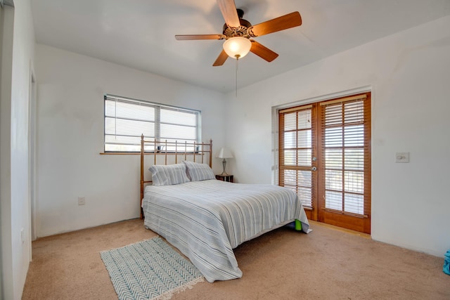 bedroom with multiple windows, light colored carpet, and ceiling fan