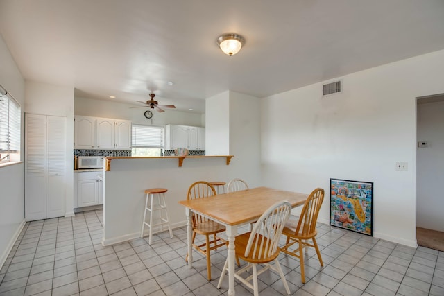 dining room featuring ceiling fan and light tile patterned floors