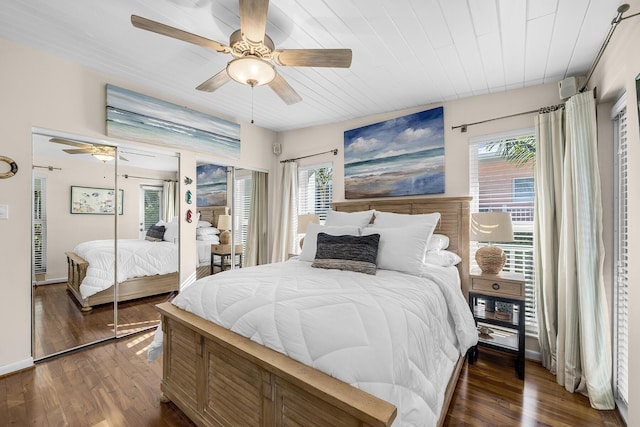 bedroom with dark hardwood / wood-style floors and ceiling fan