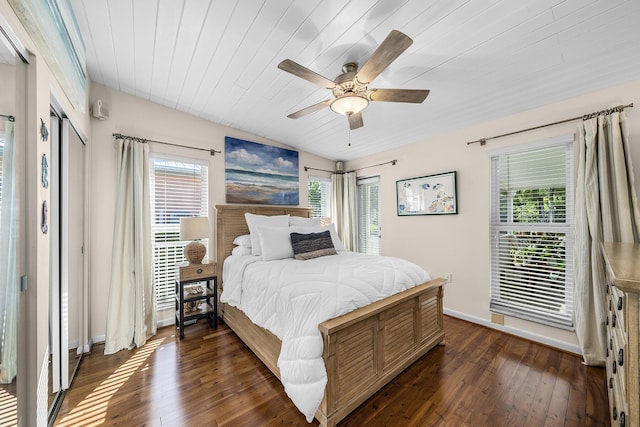 bedroom with multiple windows, ceiling fan, wood ceiling, and dark hardwood / wood-style flooring