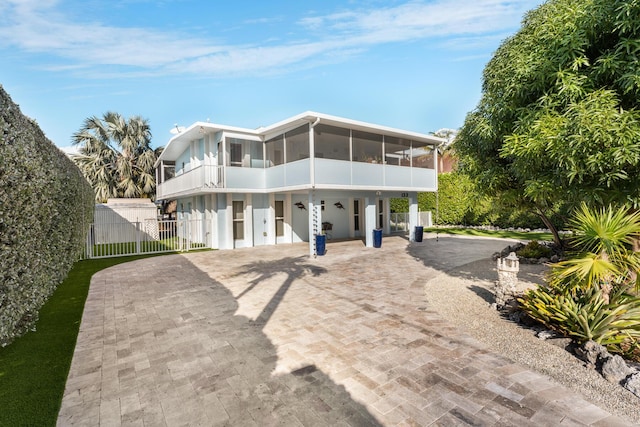 view of front of home featuring a sunroom