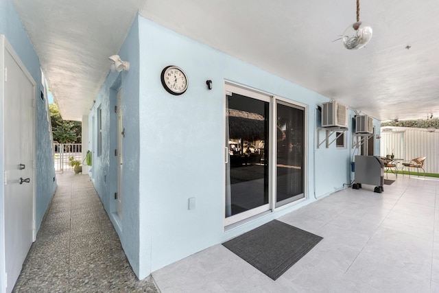 view of patio with an AC wall unit