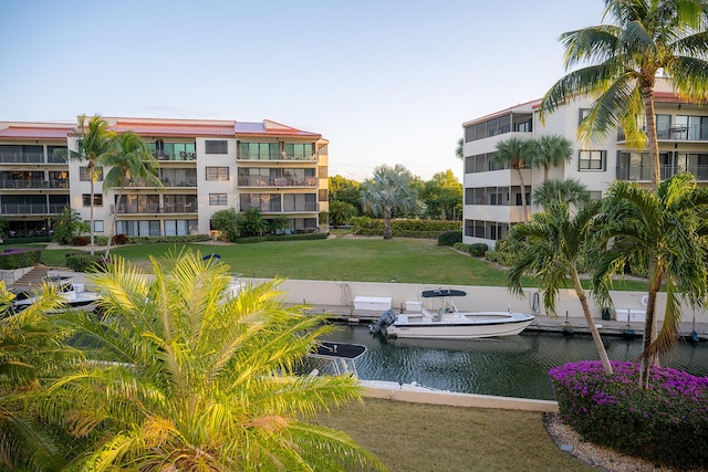 surrounding community featuring a yard and a water view