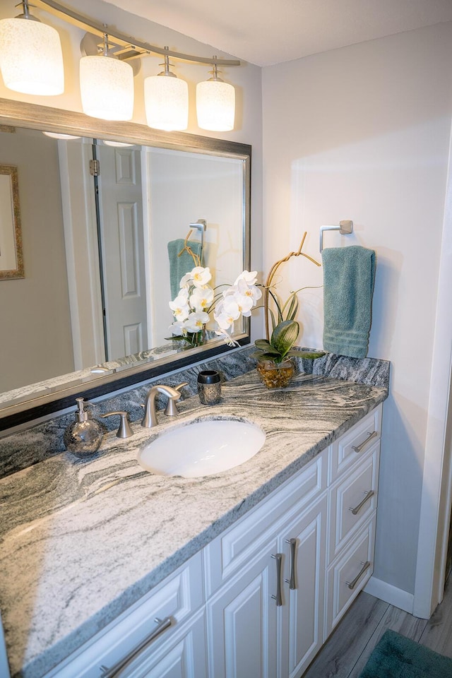 bathroom with vanity and hardwood / wood-style floors