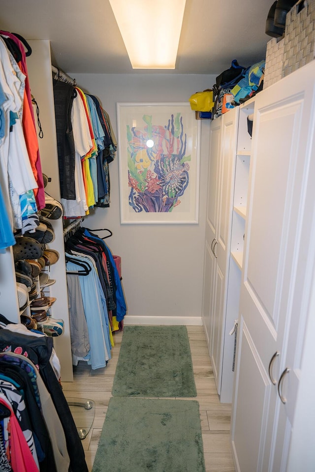 spacious closet featuring light hardwood / wood-style floors