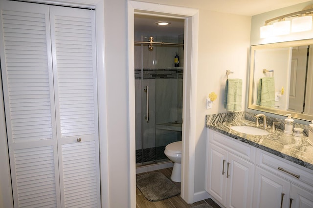 bathroom with vanity, walk in shower, and toilet