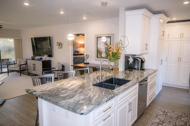 kitchen with white cabinetry, decorative light fixtures, dishwasher, and sink