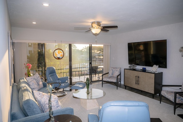 living room featuring ceiling fan and light colored carpet