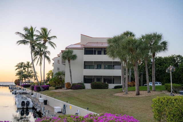 outdoor building at dusk featuring a water view