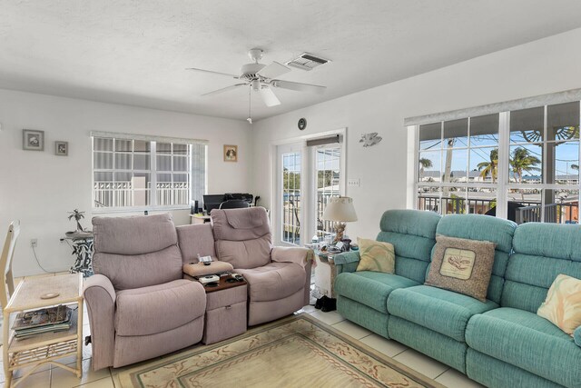 living room featuring tile patterned flooring and ceiling fan