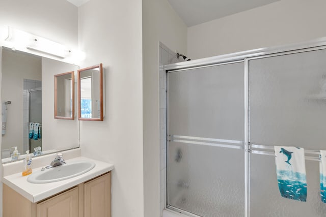 bathroom featuring vanity and an enclosed shower