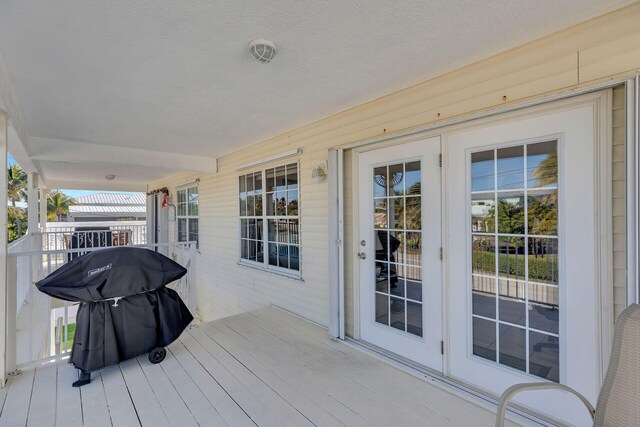 wooden terrace with a grill